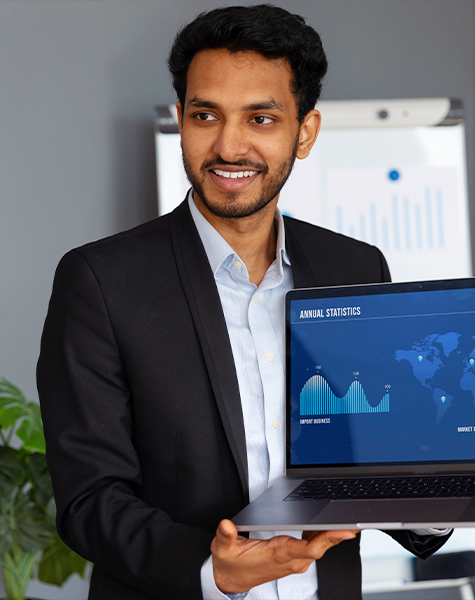 A student in professional attire showing data on the laptop