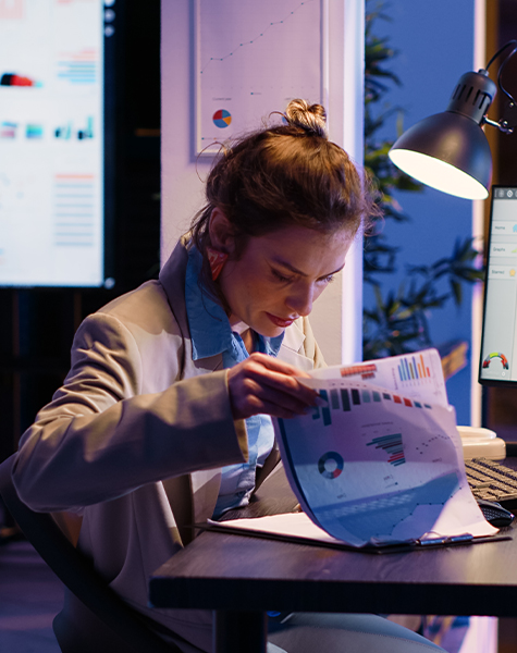 A women analysis data on the hard copy she is having