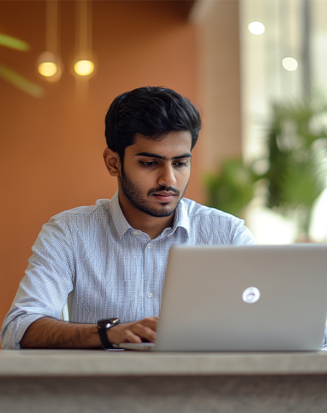 image of a male student in Healthcare Finance and Accounting course of futureace academy sitting infront of his laptop
